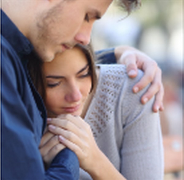 depressed woman comforted by man